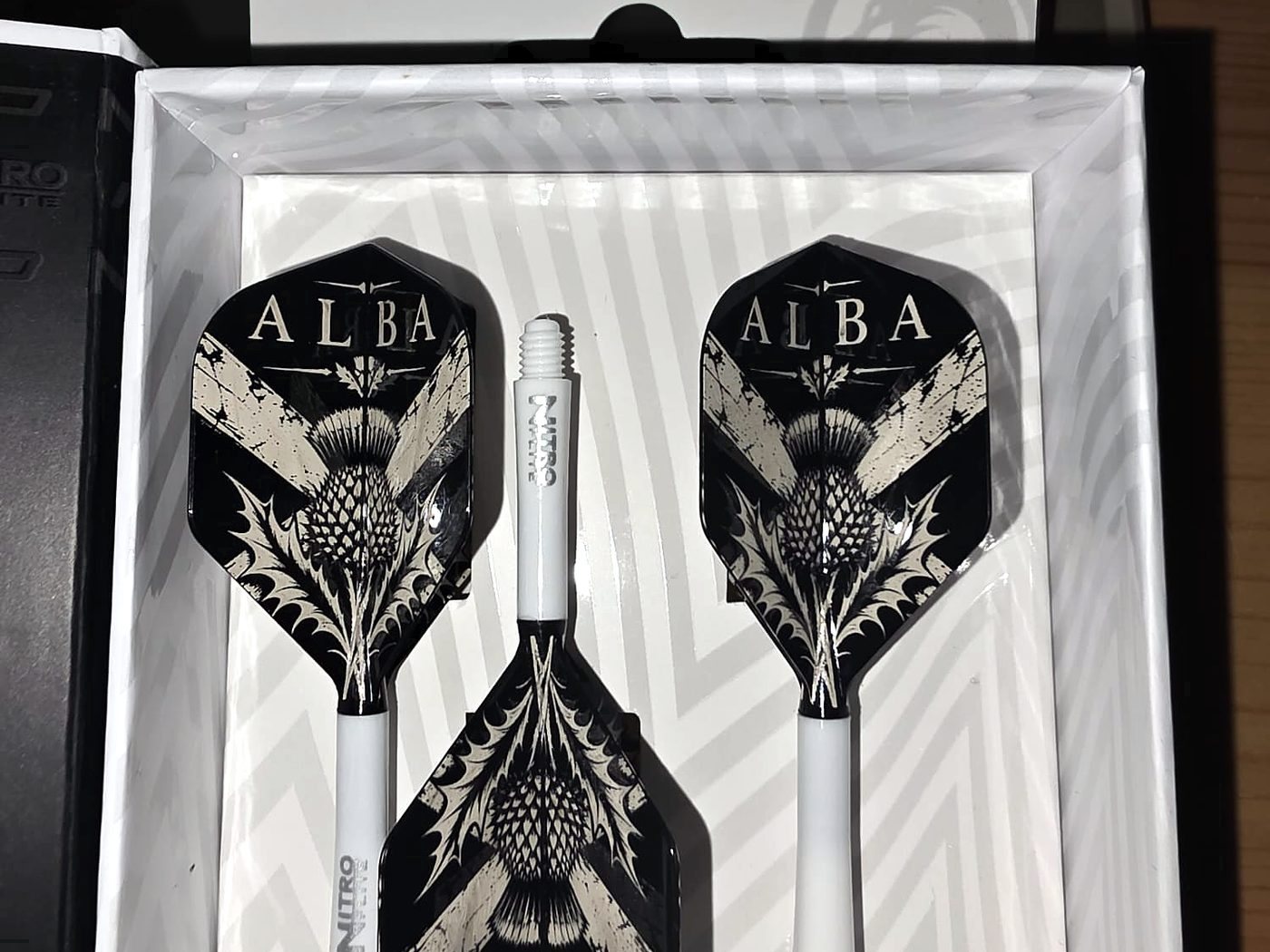 Three black flights engraved with ALBA and a Scottish thistle, presented in a white gift box