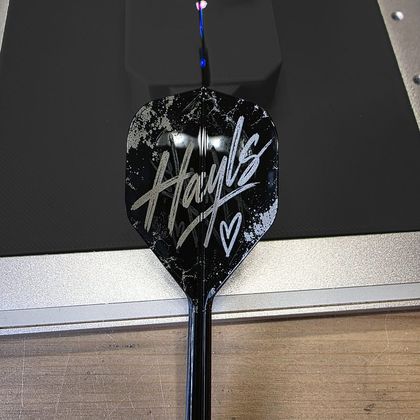 A black flight engraved with the name Hayls in white script and a small heart