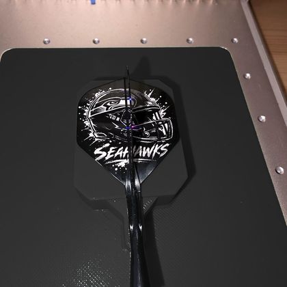 A Seahawks helmet design on a black flight