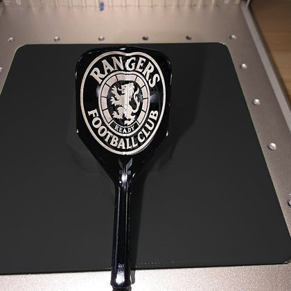 The Rangers Football Club crest engraved on a black flight
