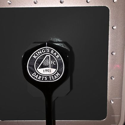 The King's Bar Darts Team crest on a single black flight