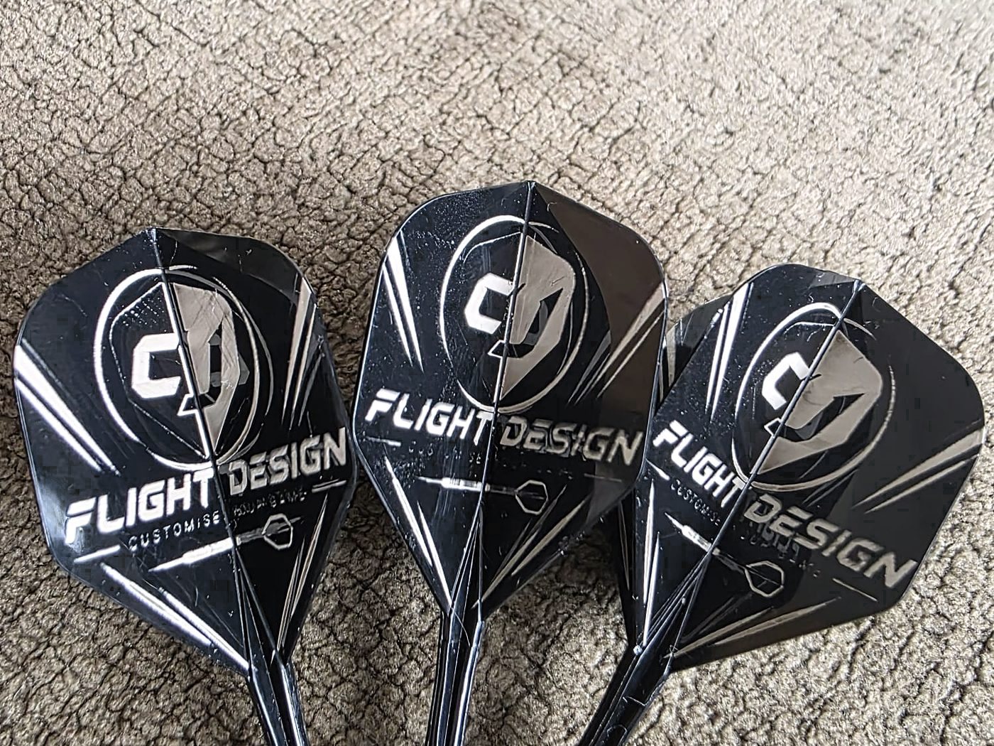 Three black flights engraved with the CJ Flight Design logo, laid side by side