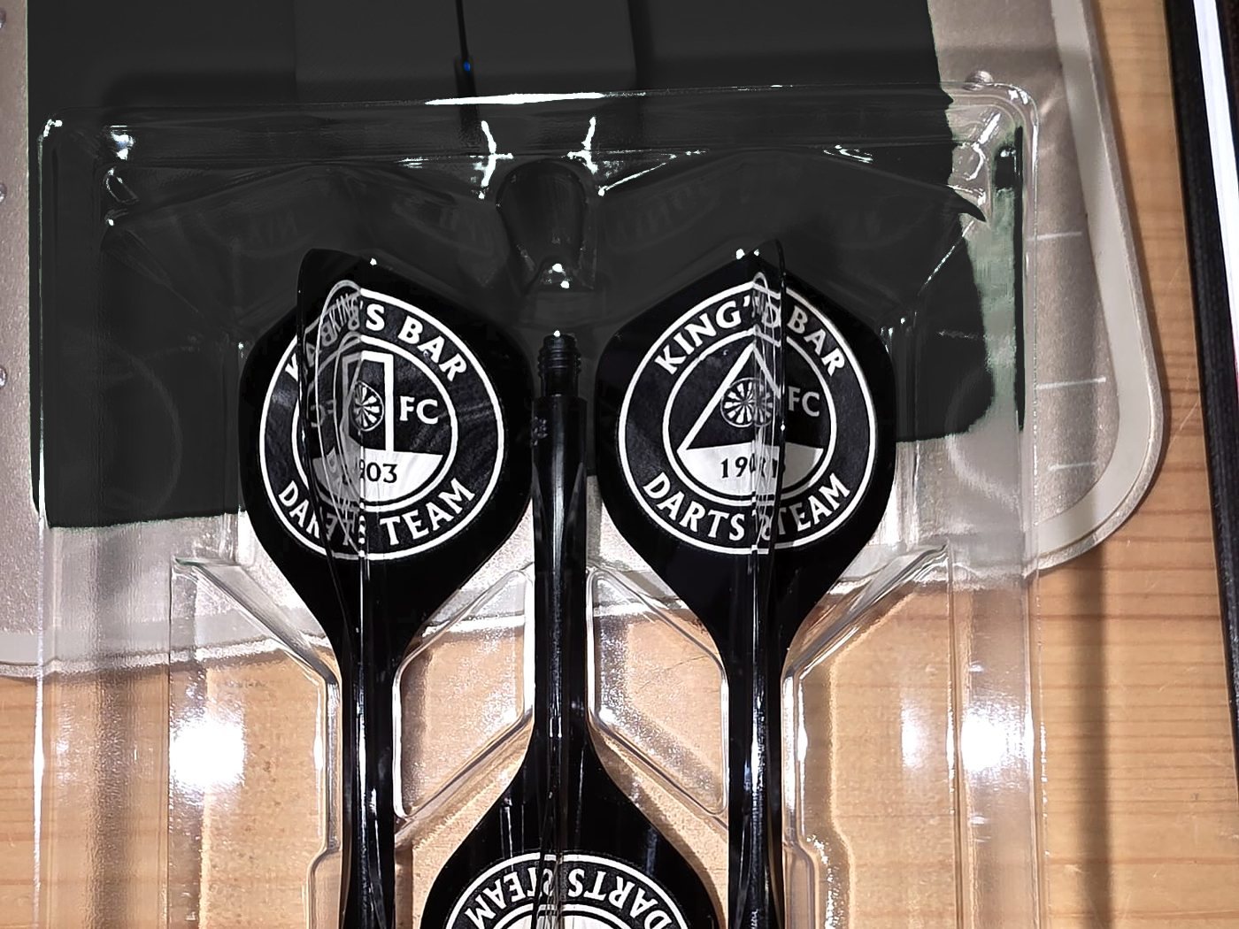 A matching set of black flights engraved with the King's Bar Darts Team crest