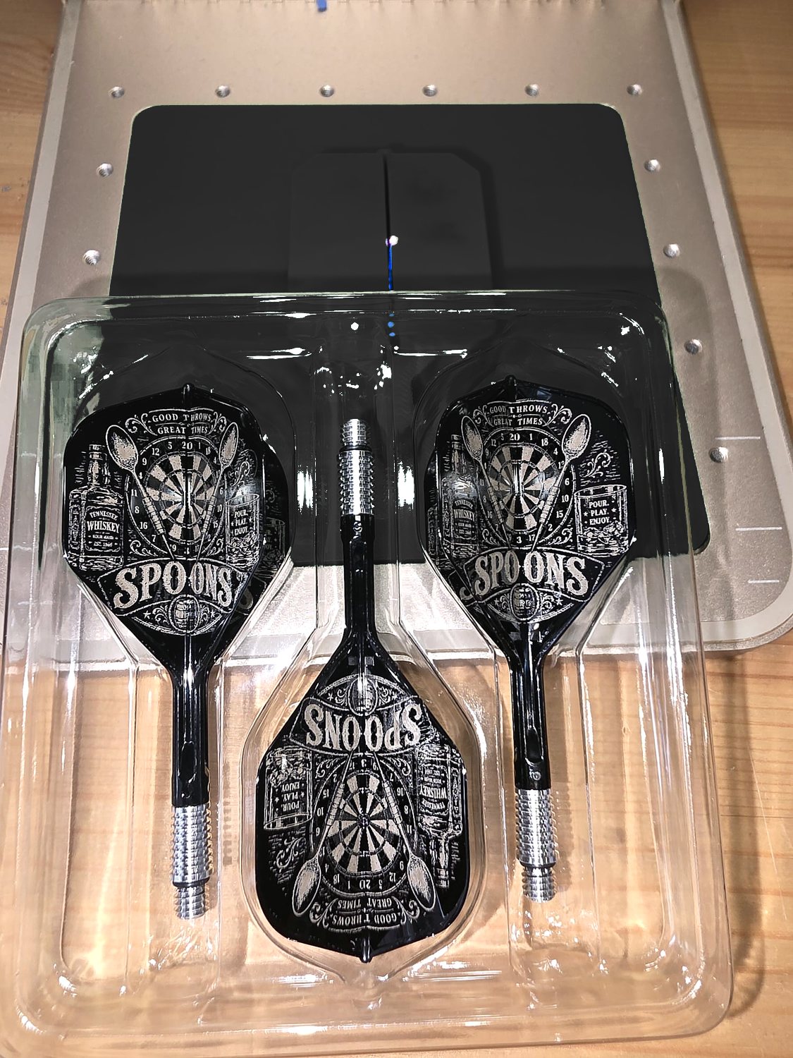 A Spoons darts team set engraved with a dartboard and pints